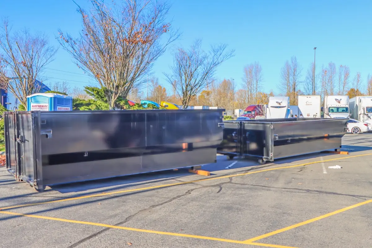 Professional dumpster rental service with roll-off container on residential driveway in Apple Valley